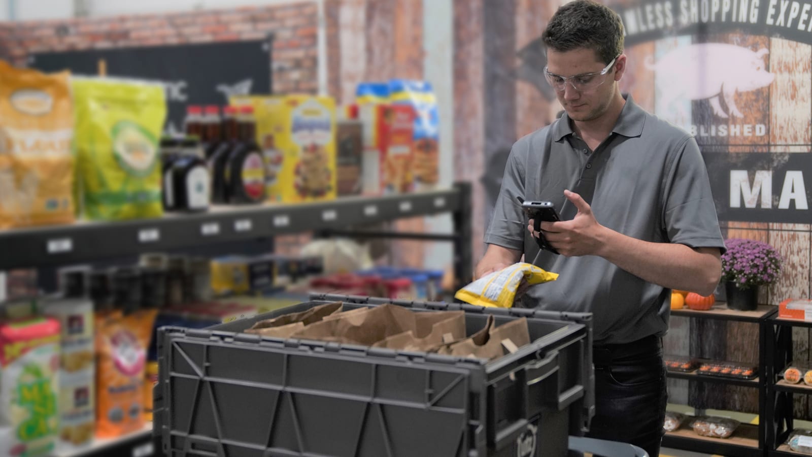 Employee checking grocery pallet inventory