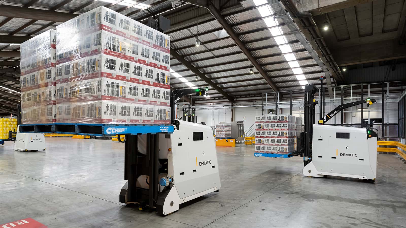 Multiple AGVs moving beverage pallets in warehouse