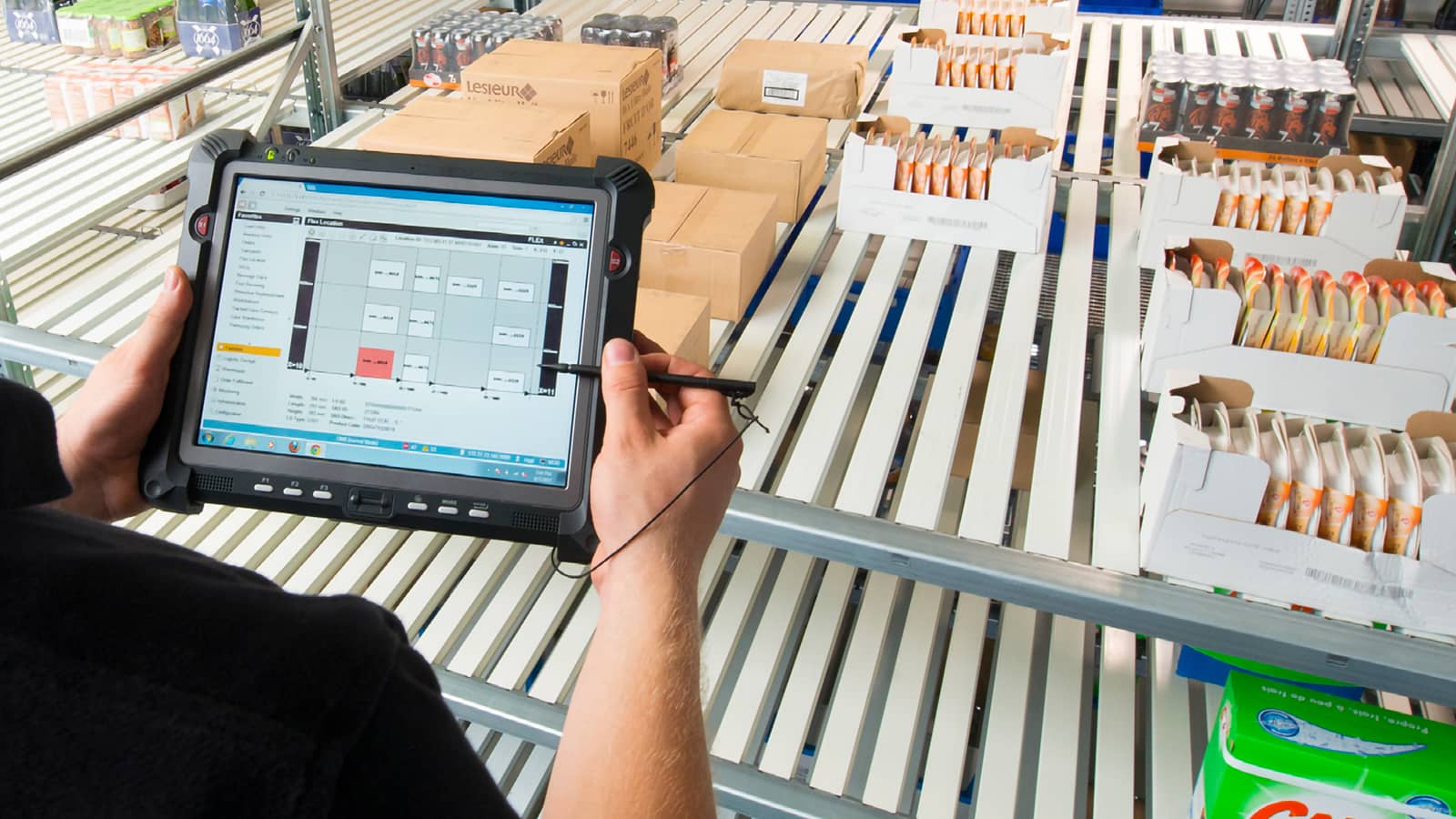 Male hands taking inventory of goods on tablet Male hands taking inventory of goods on tablet