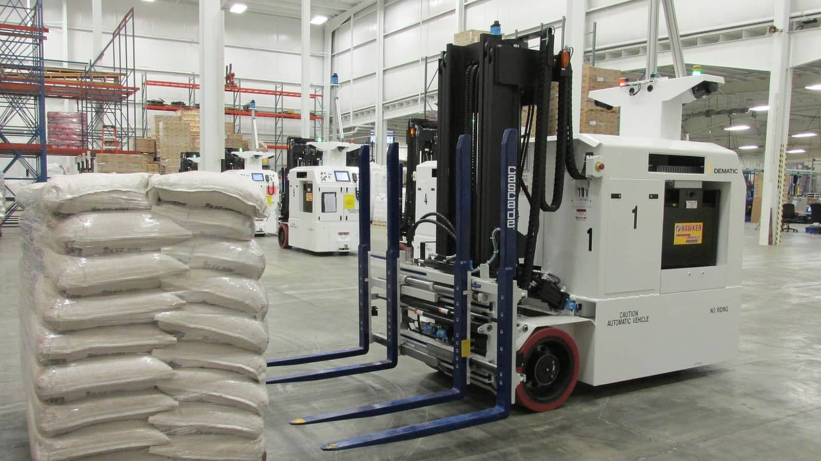 Dematic AGV shown approaching a pallet of product in an automated warehouse